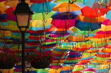 Fototapeta na wymiar Colorful umbrellas in the street. Agueda, Portugal
