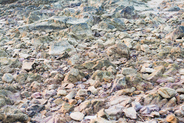 Pieces of colorful rock on the beach,  Rayong, Thailand