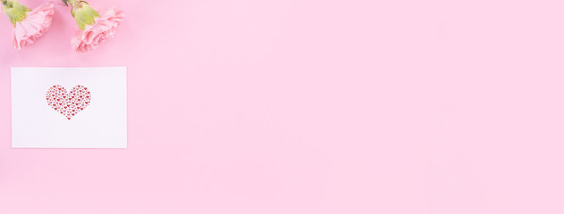 Beautiful, fresh elegant carnation flower bouquet with white greeting thanks gift card isolated on bright pink color background, top view, flat lay concept.