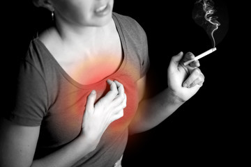 Woman smokes cigarette and has problem with lungs or heart attac