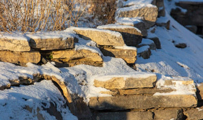 Stone bricks in the snow in winter at dawn