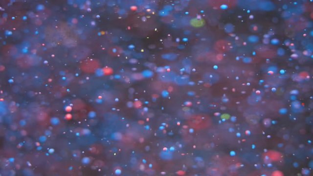 Bright Festive Background. Chaotic Motion Particles. Colorful Bubbles Oil Beautiful Paint Multi Colored Universe Moving. Space Galaxy Planets. Surface Slow Motion. Bokeh Holiday Christmas Background.