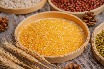 Chinese traditional grains in chinese steamer on wooden table. Made of maize, mung bean, chinese red bean. Chinese traditional food concept
