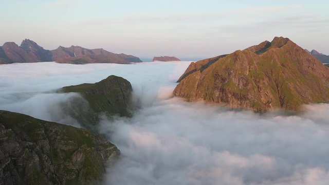 Beautiful mountain scenery during midnight sunset with epic clouds in Lofoten, Norway