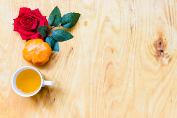 Fresh banana and persimmon in brick wall background and wooden table,