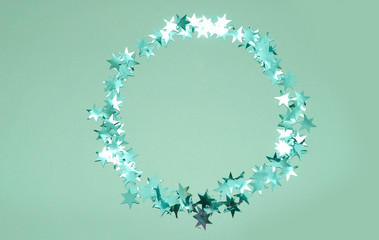 Glitters stars on mint color background.
