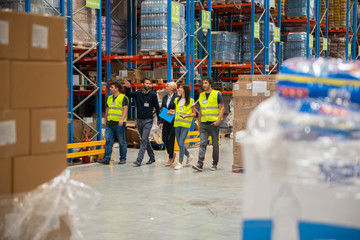 Warehouse workers in warehouse with managers