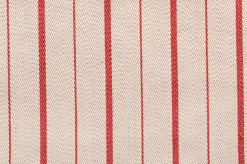 Red fabric pattern striped texture. Colored striped coarse linen fabric closeup as background.