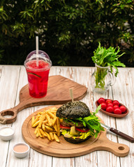 black burger served with fries