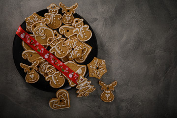 Christmas cookies with christmas ornament. Tasty homemade Christmas cookies on black plate