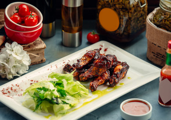 fried chicken in barbecue sauce with salad