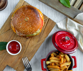 cheeseburger with side fries and ketchup