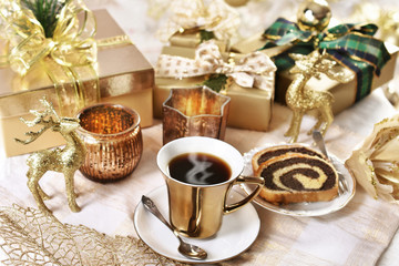 coffee in golden cup and cake for Christmas time