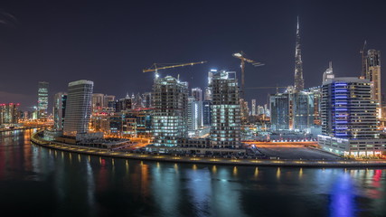 Fototapeta na wymiar The rhythm of the city of Dubai near canal aerial timelapse