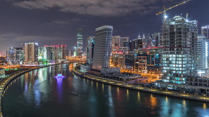 Fototapeta na wymiar The rhythm of the city of Dubai near canal aerial timelapse