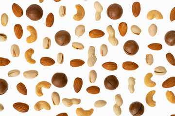 Isolated nuts pattern backdrop. Peanut, pistachio, cashew, almond, macadamia on white background. Top view.