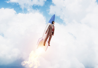 Business person in aviator hat flying on rocket