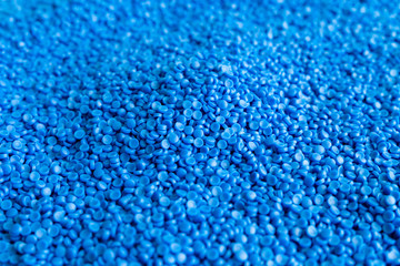 Obraz premium Close-up of plastic polymer granules. hand hold Polymer pellets. polymer plastic. compound polymer.