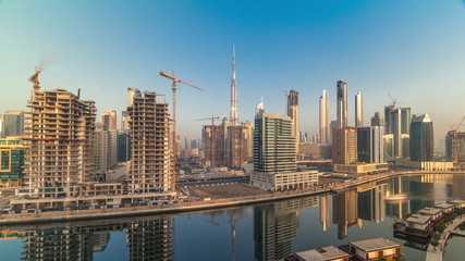 Obraz premium Skyscrapers near canal in Dubai with blue sky aerial timelapse