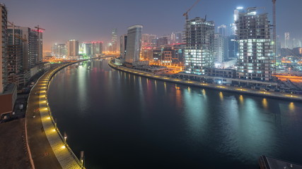 Fototapeta na wymiar The rhythm of the city of Dubai from night to day transition aerial timelapse