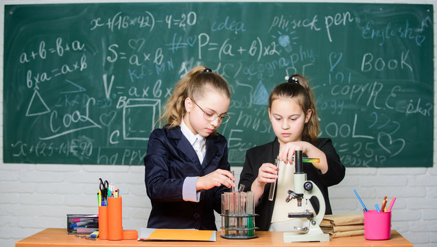 School experiment. Science concept. Gymnasium students with in depth study of natural sciences. Girls school uniform busy with proving their hypothesis. Private school. School project investigation