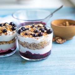 Traditional homemade French dessert of berries, grated nuts, jam and yogurt - parfait in glasses