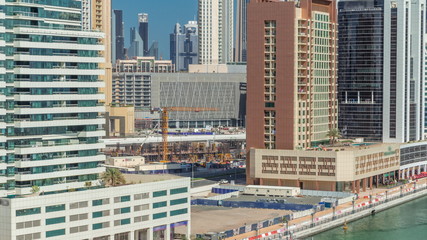 Construction in the centre of Dubai between modern skyscrapers, United Arab Emirates timelapse aerial