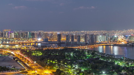 Obraz premium View of lights from illuminated roads and windows in luxury Dubai city, United Arab Emirates Timelapse Aerial