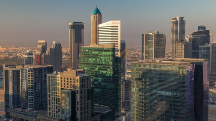 Obraz na płótnie Canvas Dubai's business bay towers at morning aerial timelapse.
