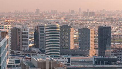 Dubai's business bay towers at evening aerial timelapse.