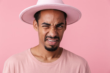 Photo of displeased african american man winking and looking aside
