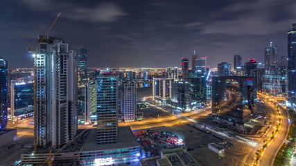 Fototapeta na wymiar Aerial view of illuminated buildings and high traffic in modern Dubai city, United Arab Emirates Timelapse Aerial