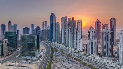 Modern residential and office complex with many towers aerial timelapse at Business Bay, Dubai, UAE.