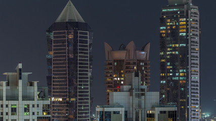 Nighttime view of lights from skyscrapers at evening in Dubai aerial timelapse