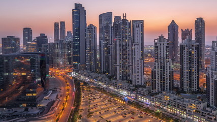 Fototapeta na wymiar Modern residential and office complex with many towers aerial day to night timelapse at Business Bay, Dubai, UAE.