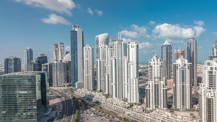 Modern residential and office complex with many towers aerial timelapse at Business Bay, Dubai, UAE.