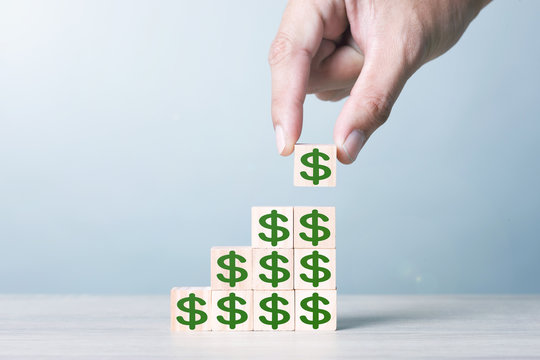 Wood block cubic stacking step up with green Dollar Sign Blue Tone. Business growth success process. Business Concept. Up Trend.