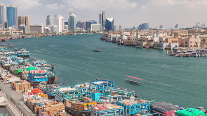 Fototapeta na wymiar Loading a ship in port timelapse in Dubai, Deira creek, UAE.