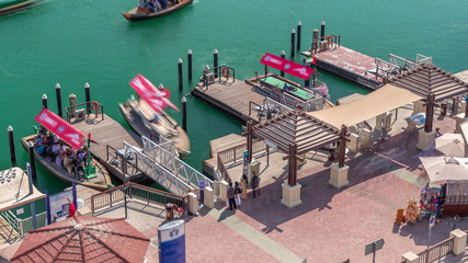 A water taxi boat station in Deira aerial timelapse.