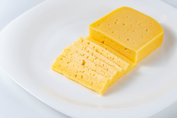 Cheese Sliced on White Plate