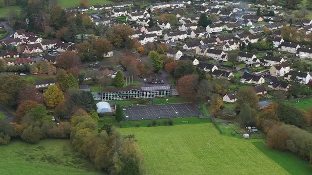 Aerial orbit view of Dulverton Junior School, located on the River Barle on the edge of Exmoor, UK.