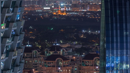Fototapeta na wymiar Aerial view to neighbourhood Deira and Dubai creek with typical old and modern buildings night timelapse.