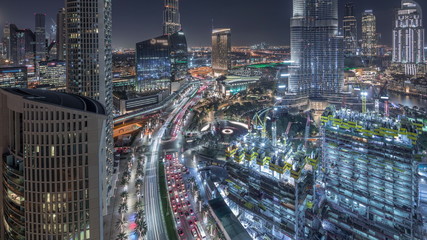 Fototapeta na wymiar Panoramic skyline view of Dubai downtown with mall, fountains and skyscrapers aerial night timelapse