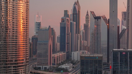 Fototapeta na wymiar Dubai International Financial Centre district with modern skyscrapers timelapse at sunrise