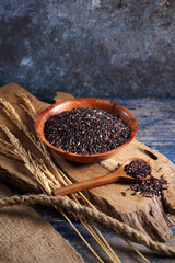 close up riceberry rice in measuring cup on table, riceberry rice in chinese kitchen background