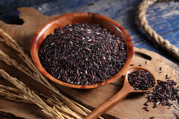 close up riceberry rice in measuring cup on table, riceberry rice in chinese kitchen background