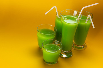 Glass of green juice with copy space for text, fresh apple and celery cocktail
