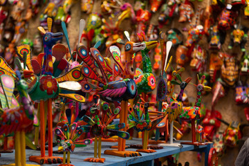 Colorful bird crafts, Antigua Guatemala handicraft market - hand-painted wooden birds