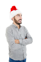 Young handsome man wearing santa claus hat over isolated background looking up on side