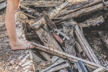 Garbage among the boards of an old collapsed house